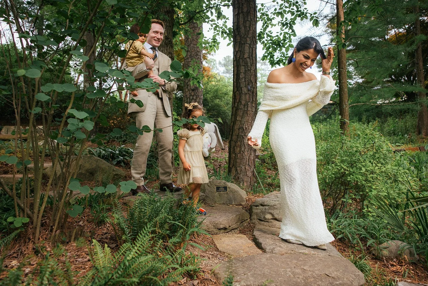 family of four explores duke gardens after vow renewal ceremony in Durham, NC