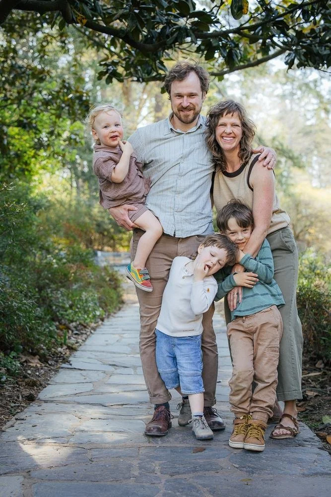 Family of five standing together on the wooden boardwalk path at Duke Gardens in Durham NC — lifestyle family photography