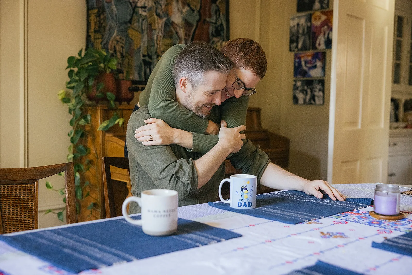 Mom and Dad Hugging Sitting on Kitchen Table
