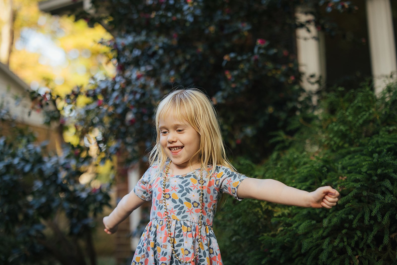 Young Girl in Flower Dress Twirling Outside
