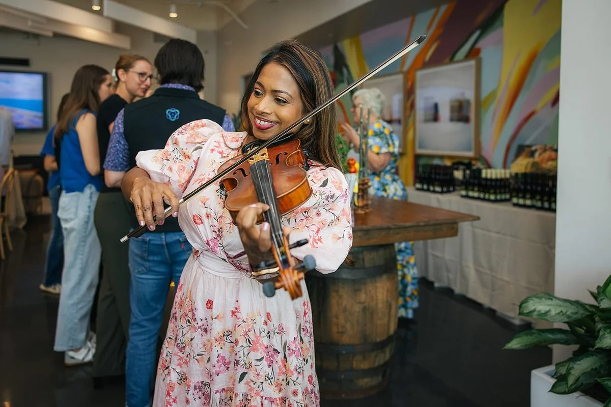 Woman playing violin at corporate event in Cary NC