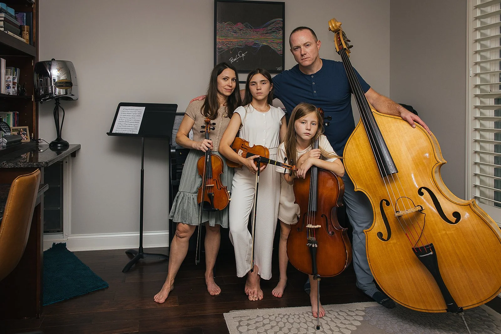 Family posing with instruments in-home family photography session Chapel Hill NC