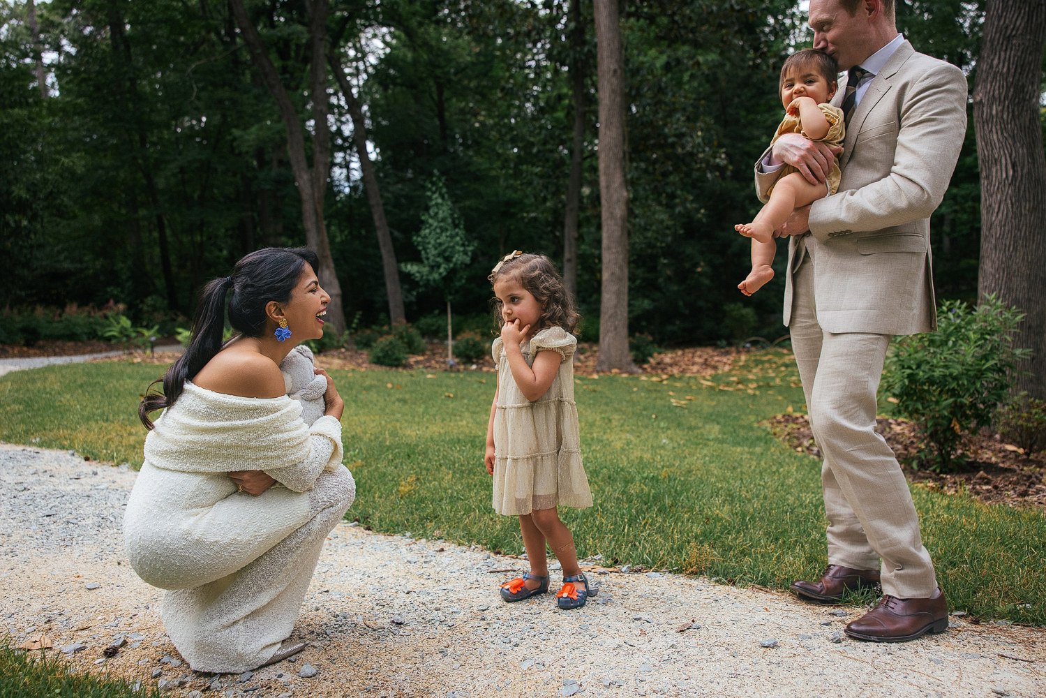 family of four explore together during a vow renewal celebration at Duke Gardens in Durham NC