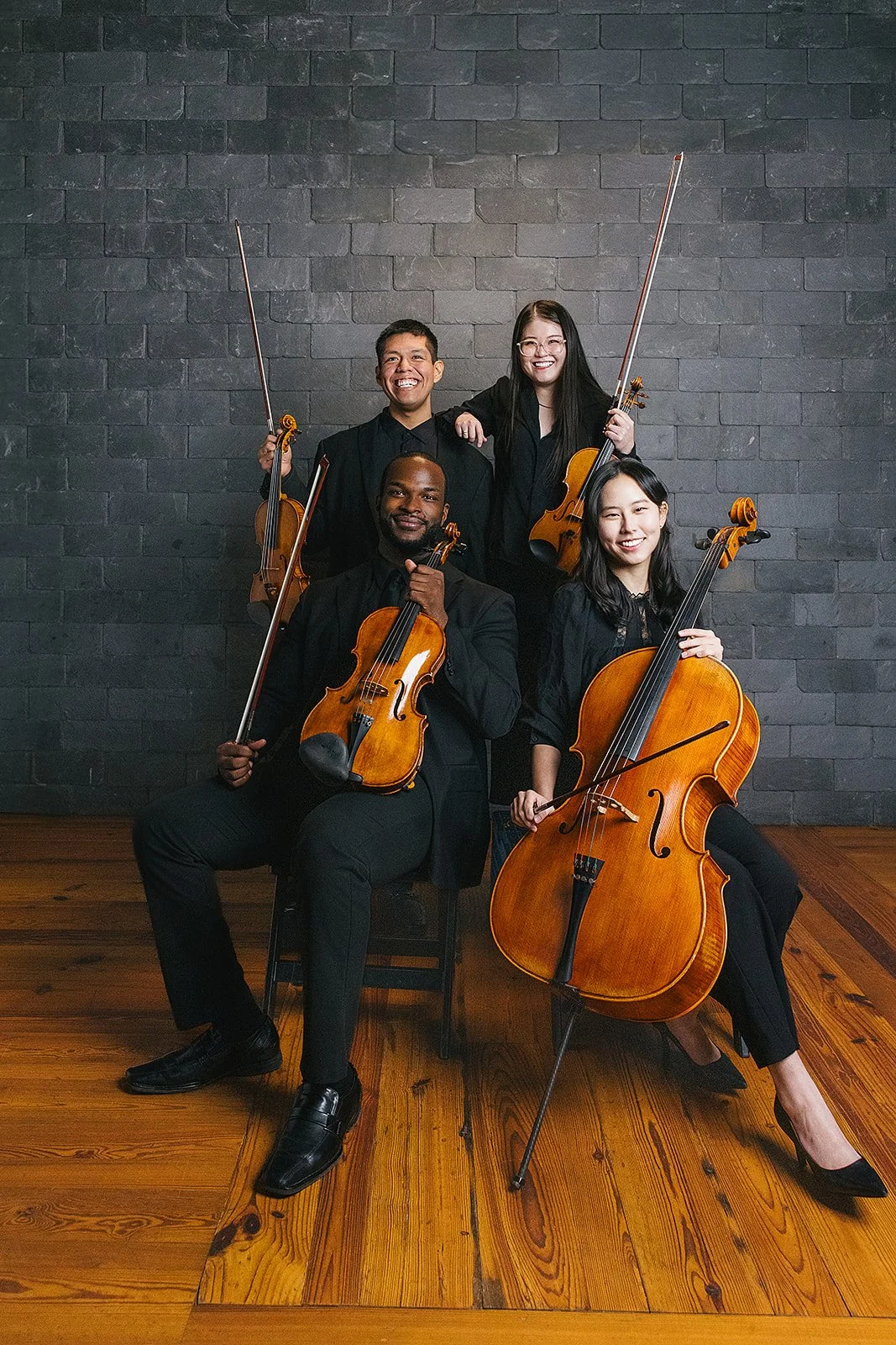 Four Members of Chamber Orchestra of the Triangle Posing with Instruments