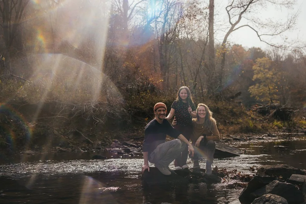 Couple and Young Girl Smiling While in Creek Durham NC