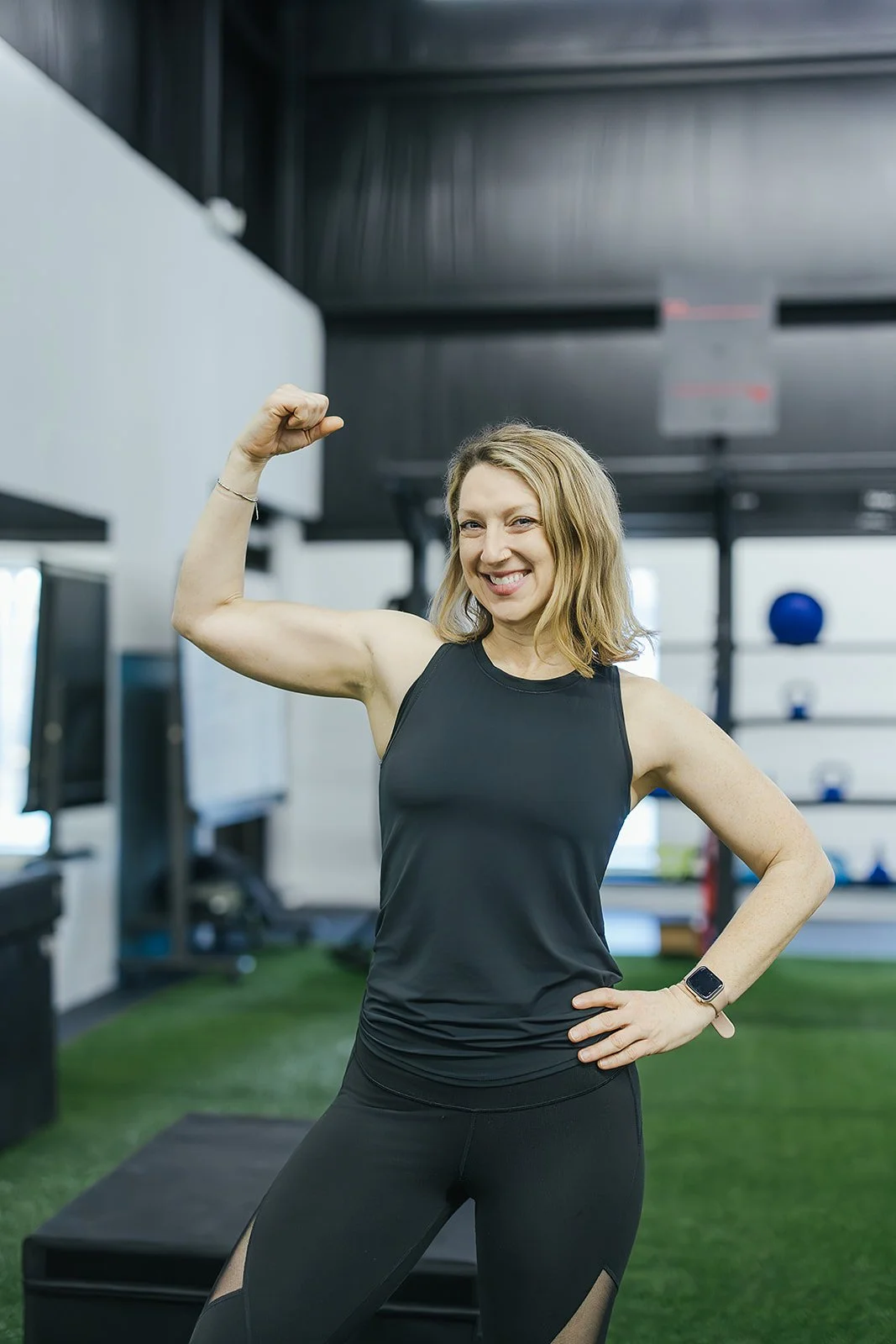 woman displays her muscles during a sports club photoshoot
