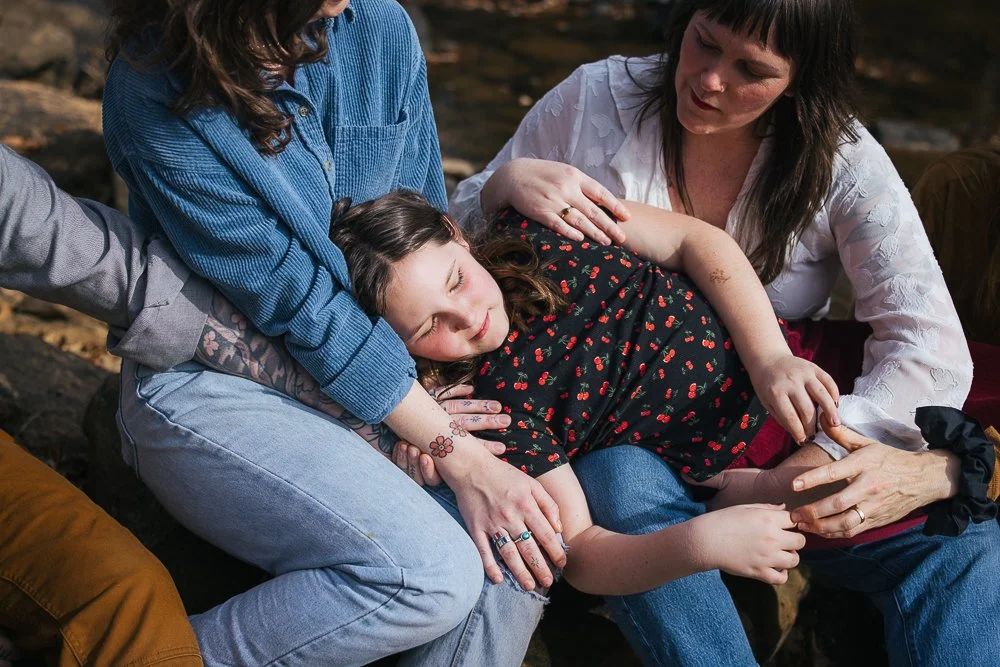 Young Girl Sitting with Friends by River in Durham NC