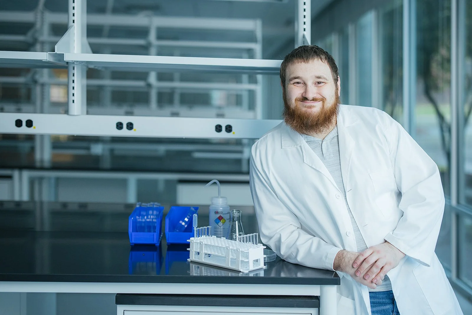 ManInWhiteLabCoatSmilingInLab