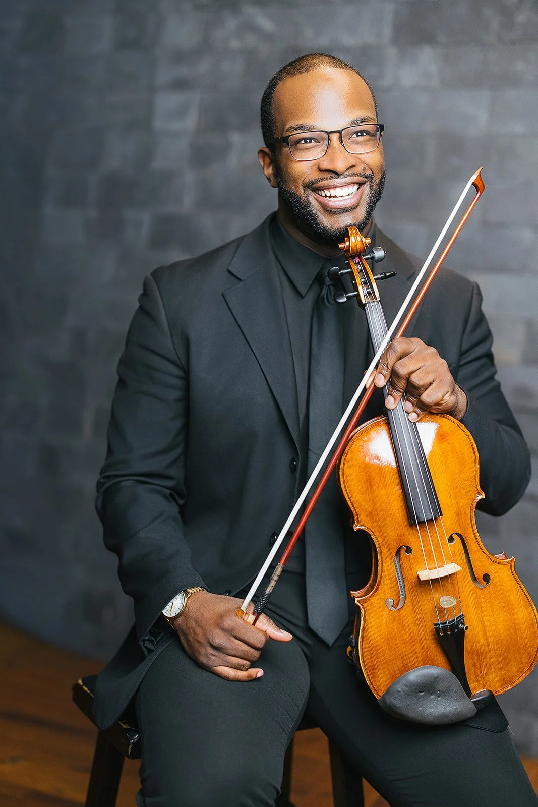 Man Smiling Holding Violin Chamber Orchestra of Triangle Branding Session