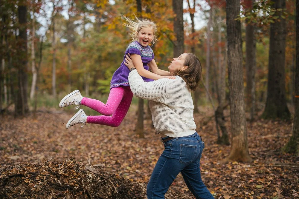 Mom swinging daughter around in air