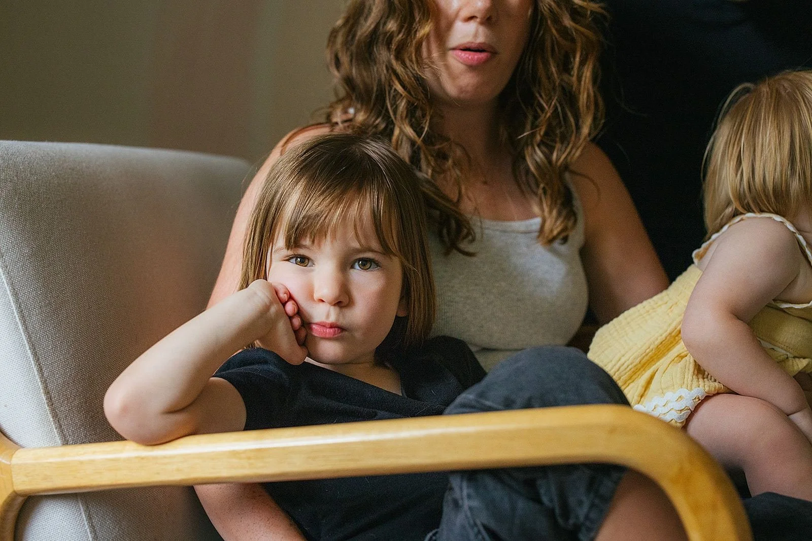 Children Sitting With Mom in Chair During Family Photography Session