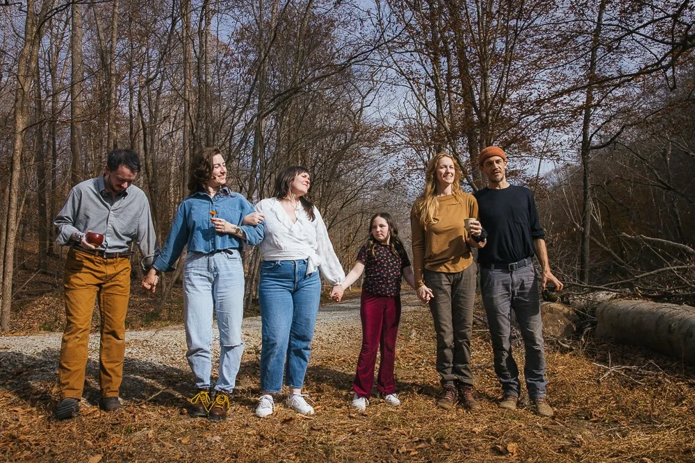 Friends Holding Hands Walking Through Woods Outside