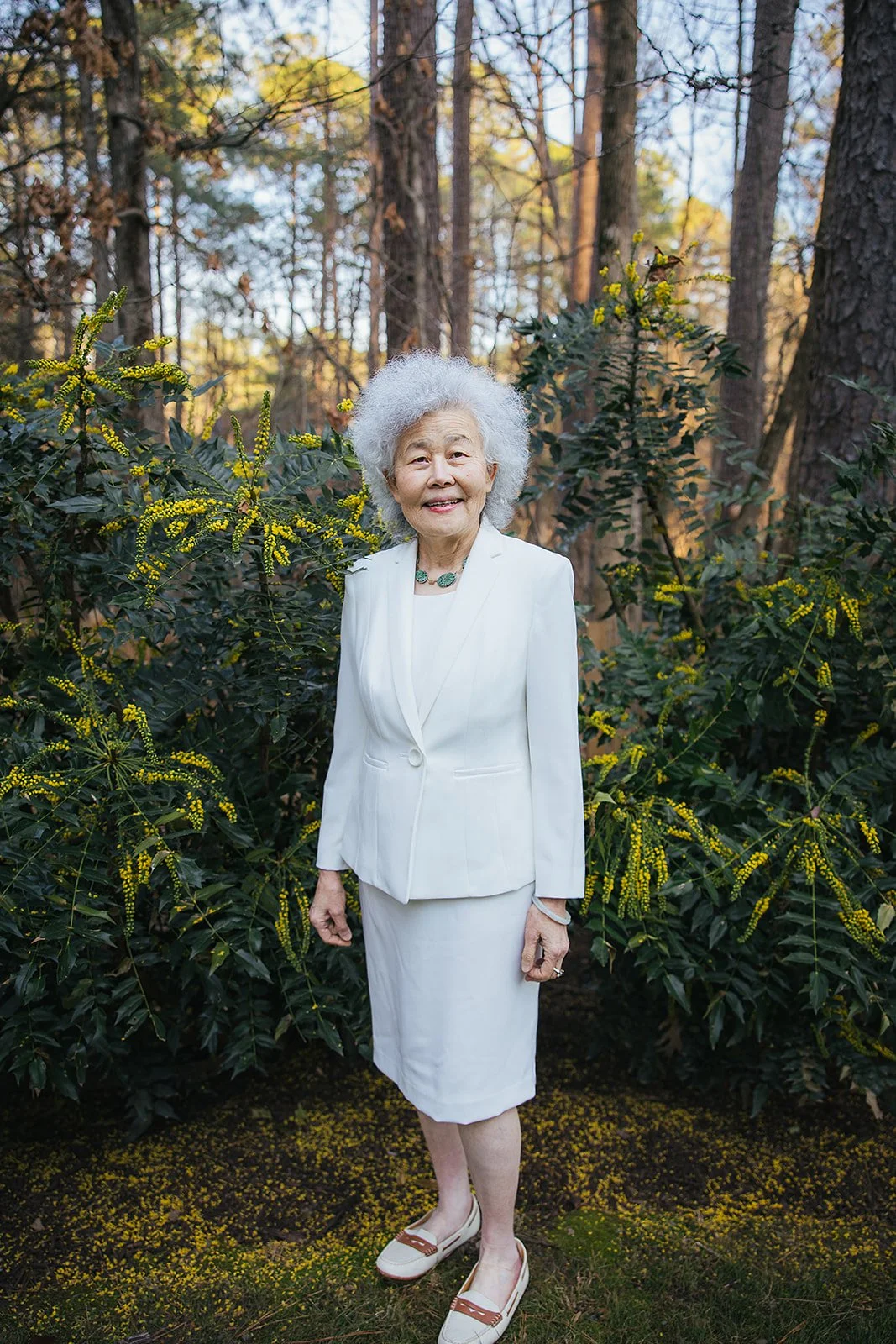 Portrait outside grandmother in white outfit outside