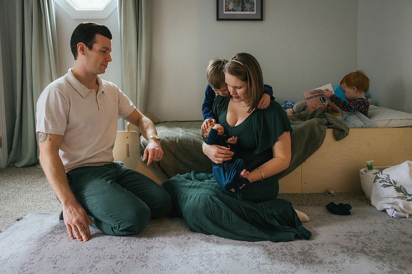 Family of five pose at home for a newborn photoshoot in Durham, NC