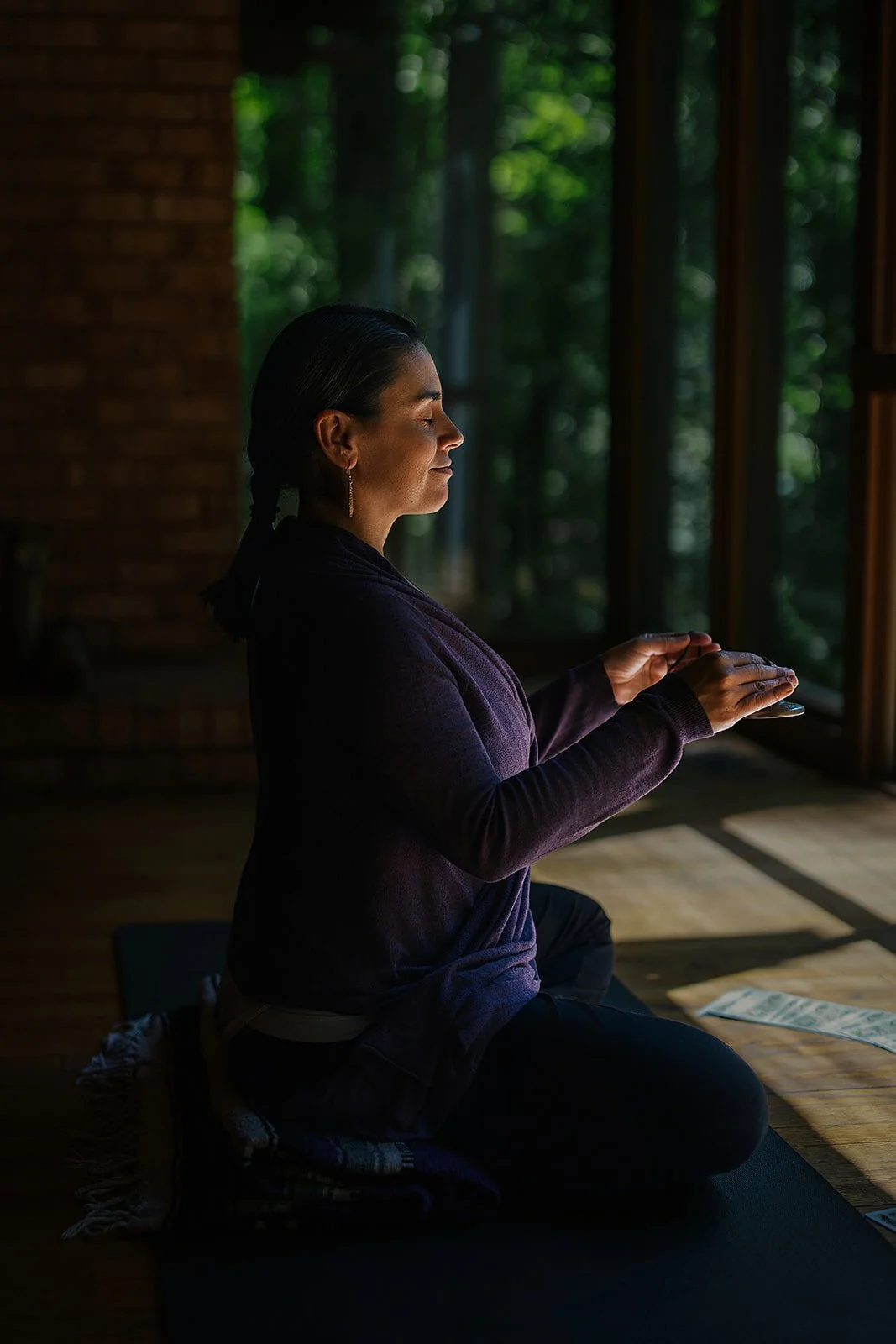 Yoga teacher practicing outdoors among the trees at The Trees in Durham, NC