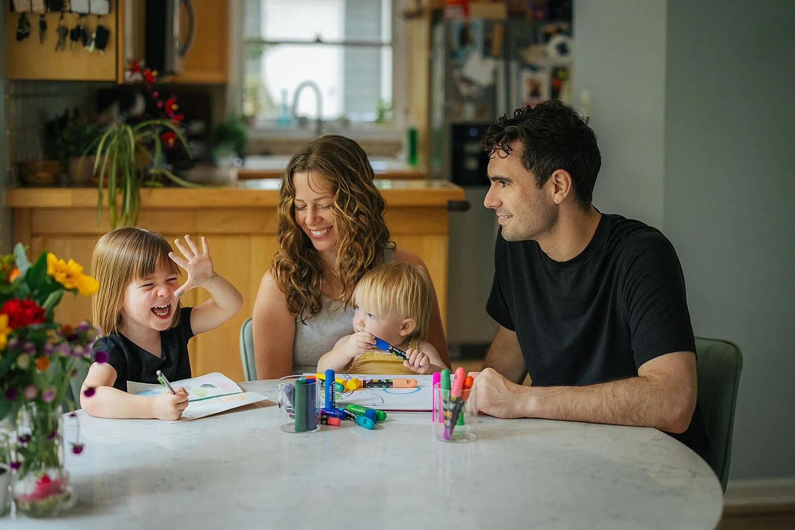Family Sitting at Table and Coloring Together In-Home Family Photography Session