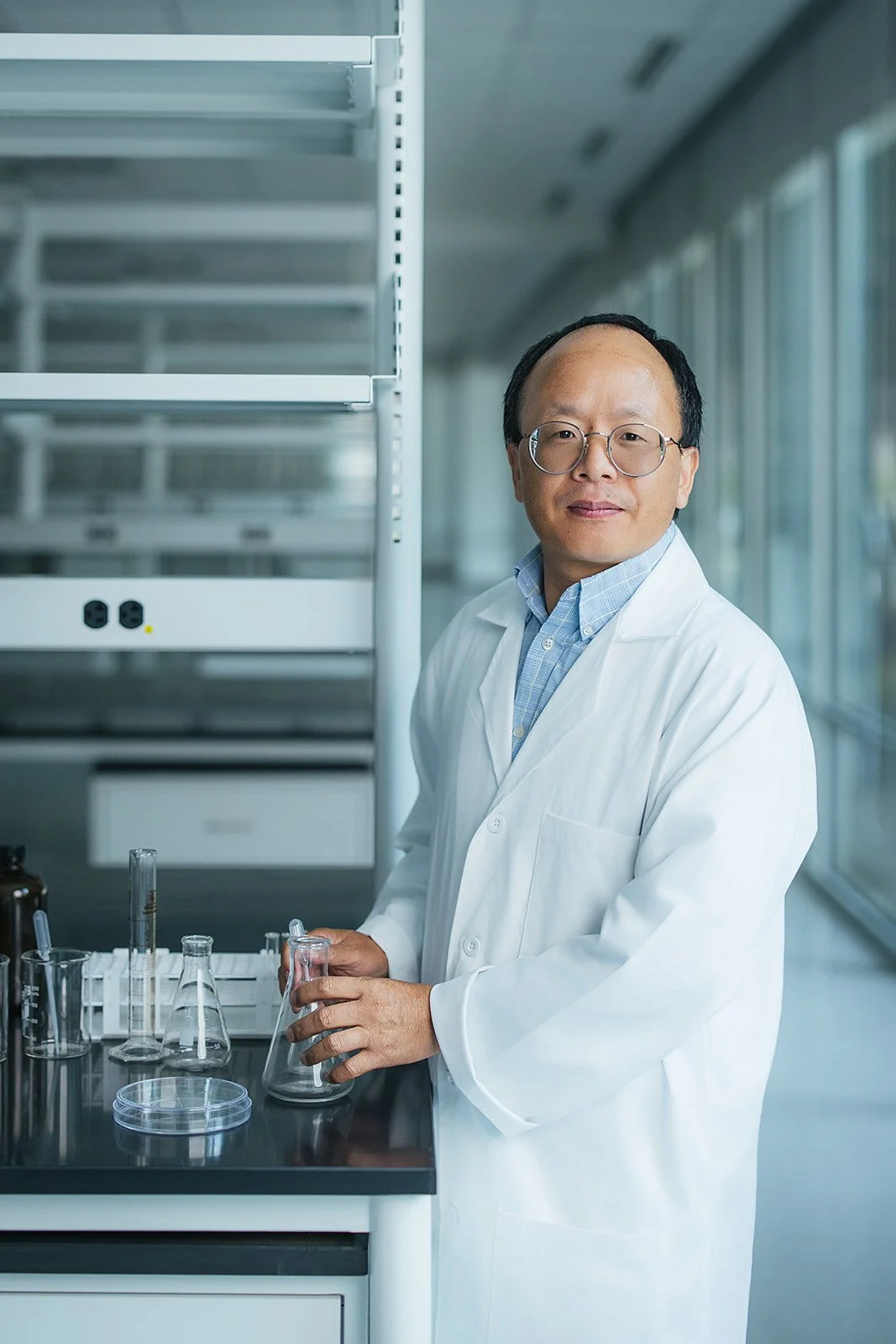 ManInWhiteLabCoatHoldingBeaker