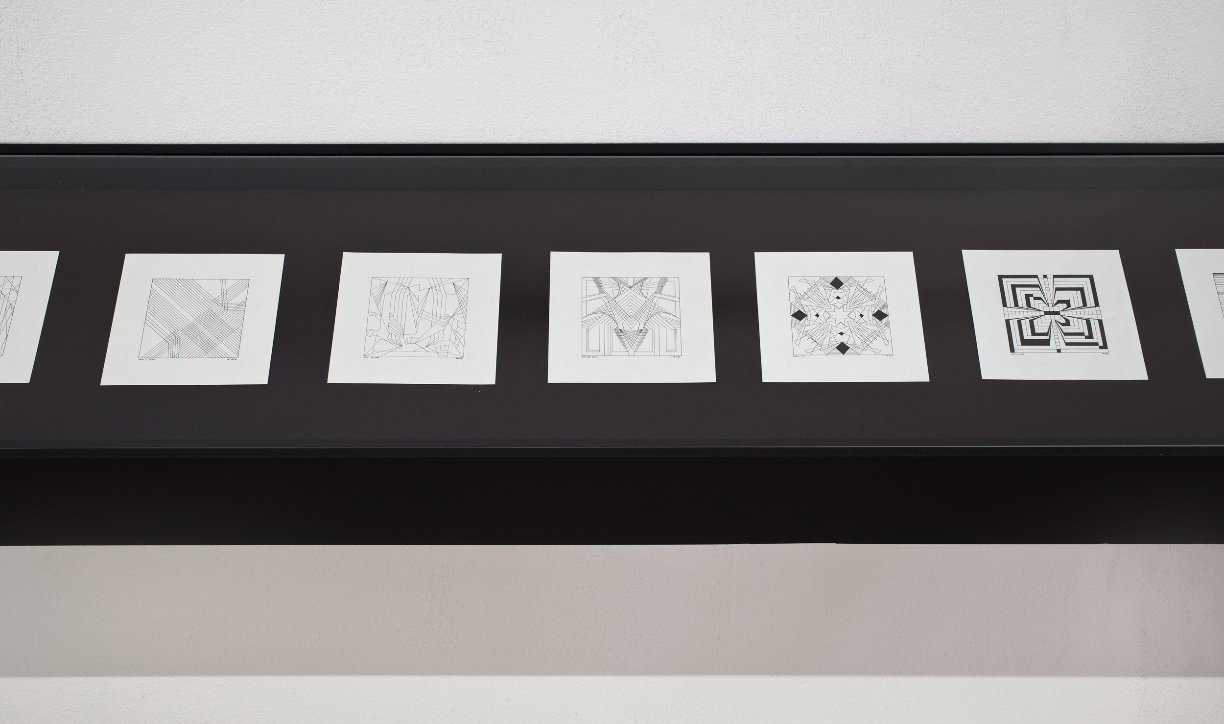    Scheherazade    Tape on wall, ink drawings on paper in wooden shelves 