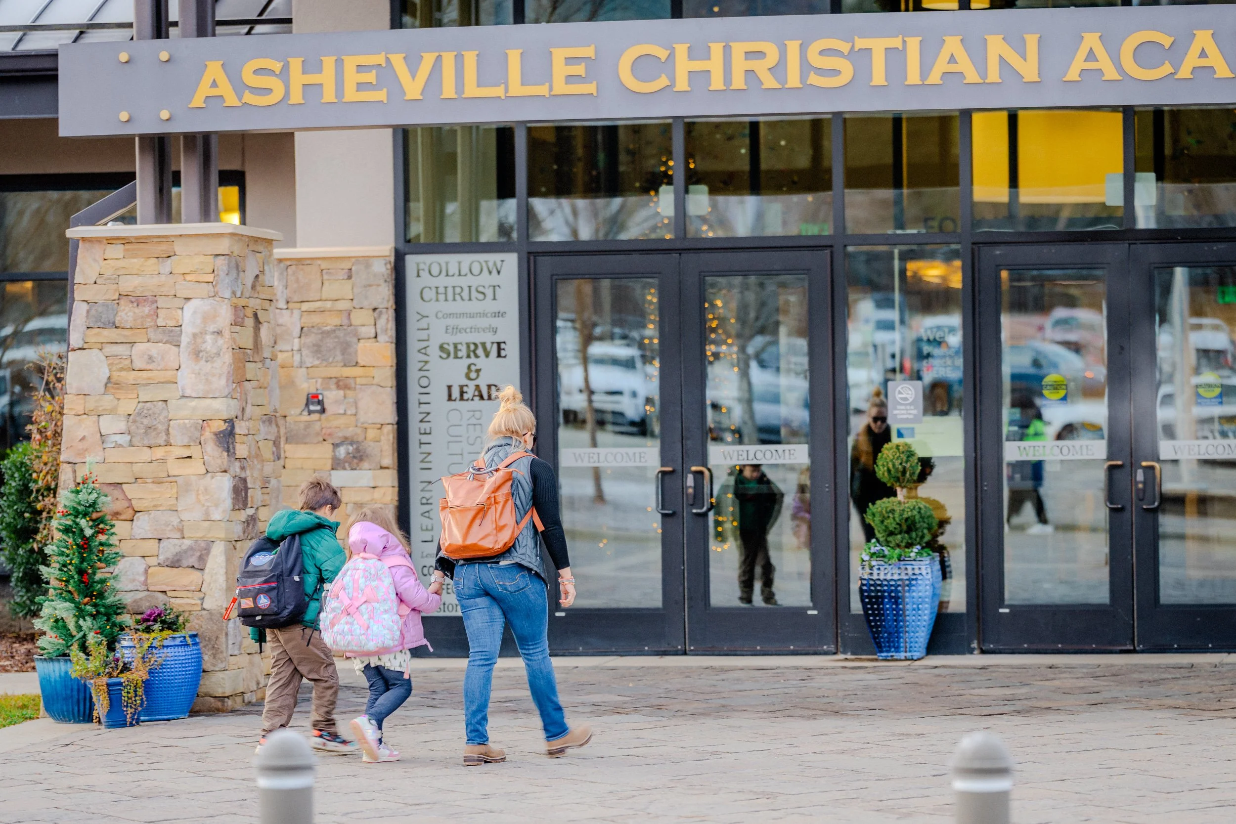 Mother walking with her children into Asheville Christian Academy