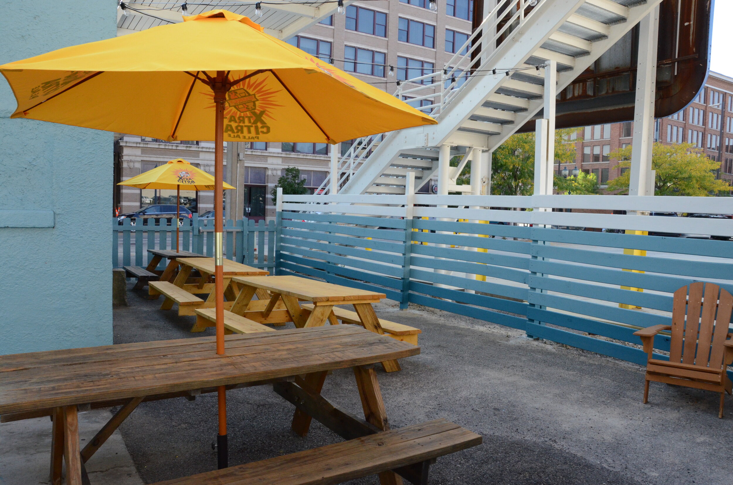 Our back patio seats about 28 people for dining on picnic benches (pictured). The front patio can accommodate up to 20 for drinks and socializing. 