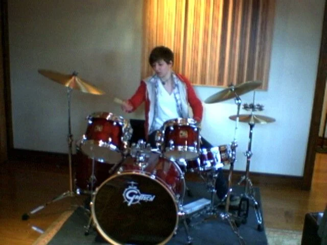 Trying to fake my way through playing a drum kit.  I stick mostly to electronic drums now.
