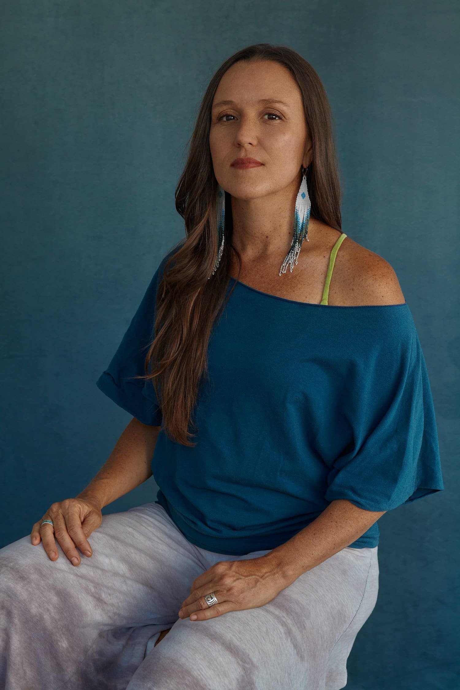 Personal PhotoShoot captures a beautiful woman in blue attire, her style influenced by Zen Buddhism and Native American ideals. The Personal Branding Photographer presents this spiritual meditation piece as part of the unique Studio Portraits series