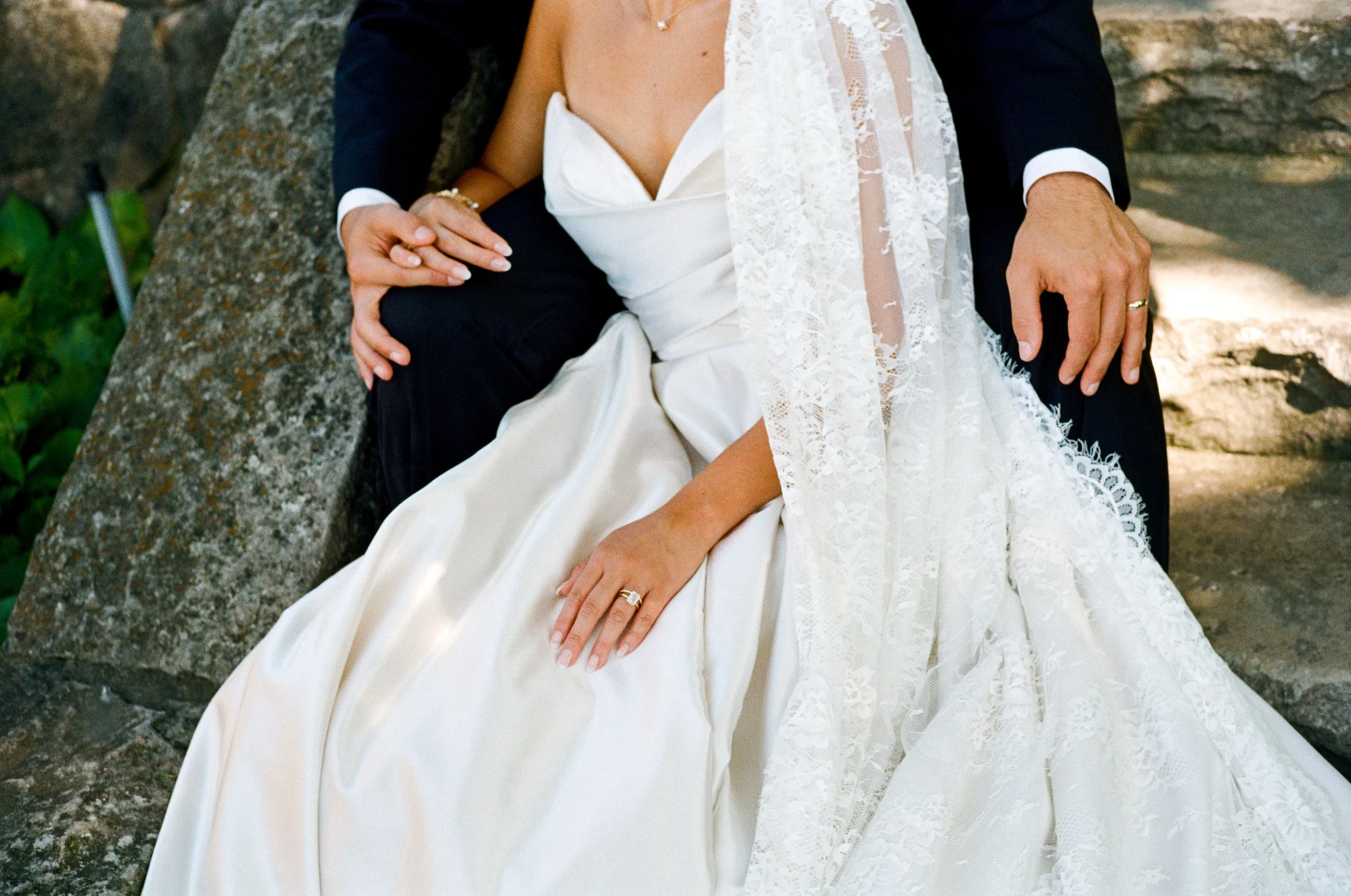 Bride and groom sitting together on the steps at the Henry Ford Fair lane Fairlane estate in Dearborn, Michigan.