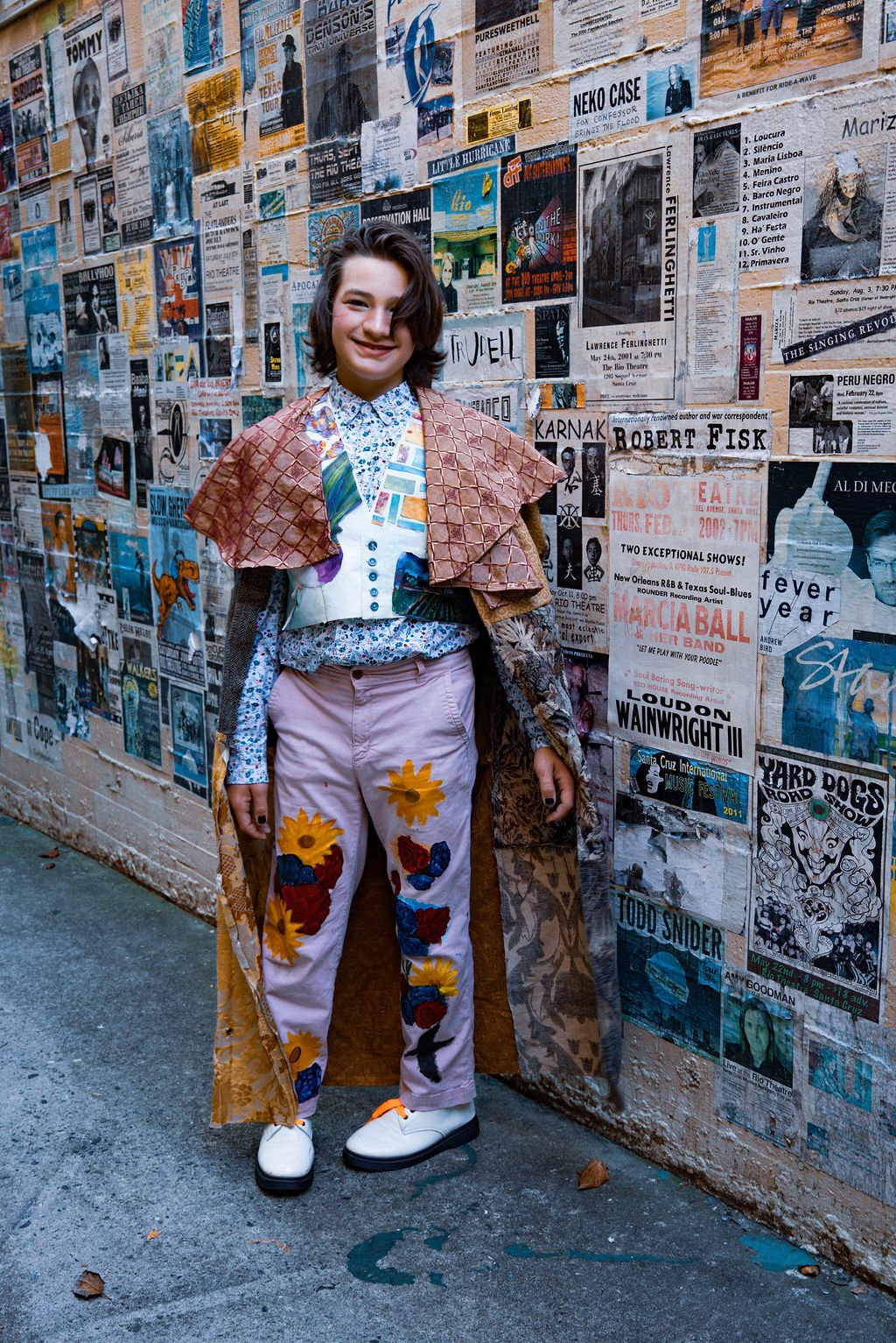 Two middle school student designers walk the FashionTeens Santa Cruz 2025 runway in playful upcycled outfits featuring bottle caps, denim scraps, and repurposed embellishments, showcasing youth creativity and sustainable fashion.