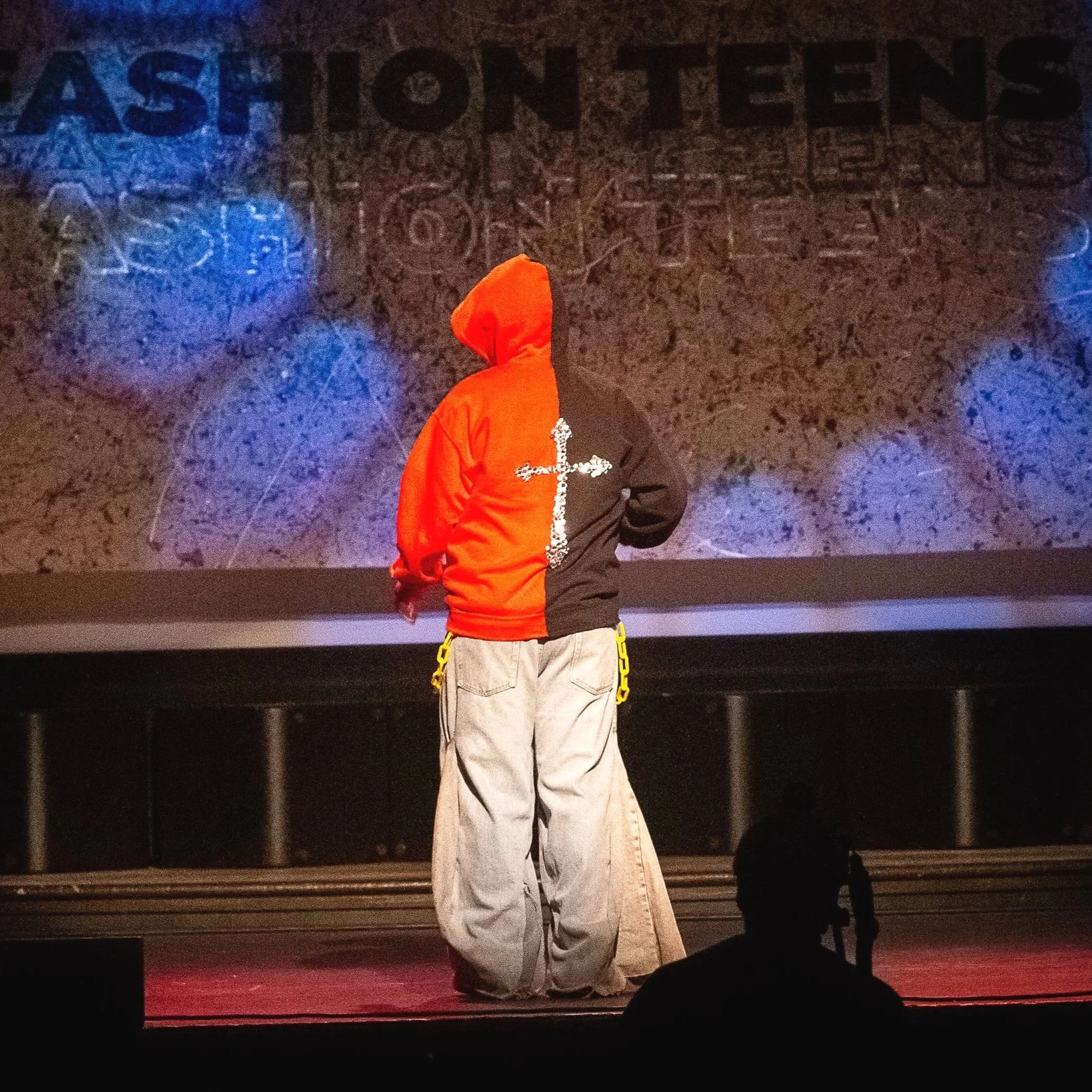 FashionTeens Santa Cruz student runway design inspired by Balenciaga, featuring extra wide jeans made from upcycled denim with repurposed sweatshirts and rhinestone details