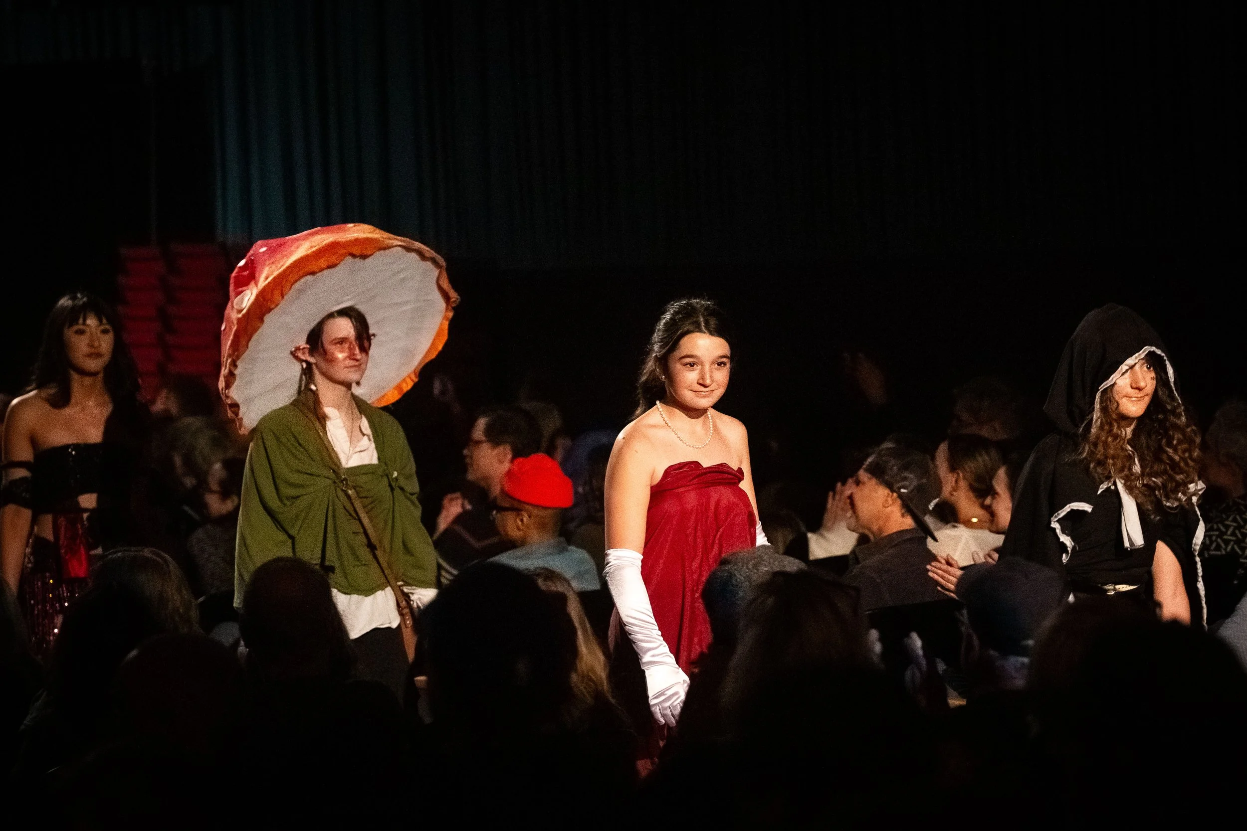 Student models walking the runway at the FashionTeens show in Santa Cruz, featuring creative, upcycled designs and handmade garments during the annual youth fashion event.