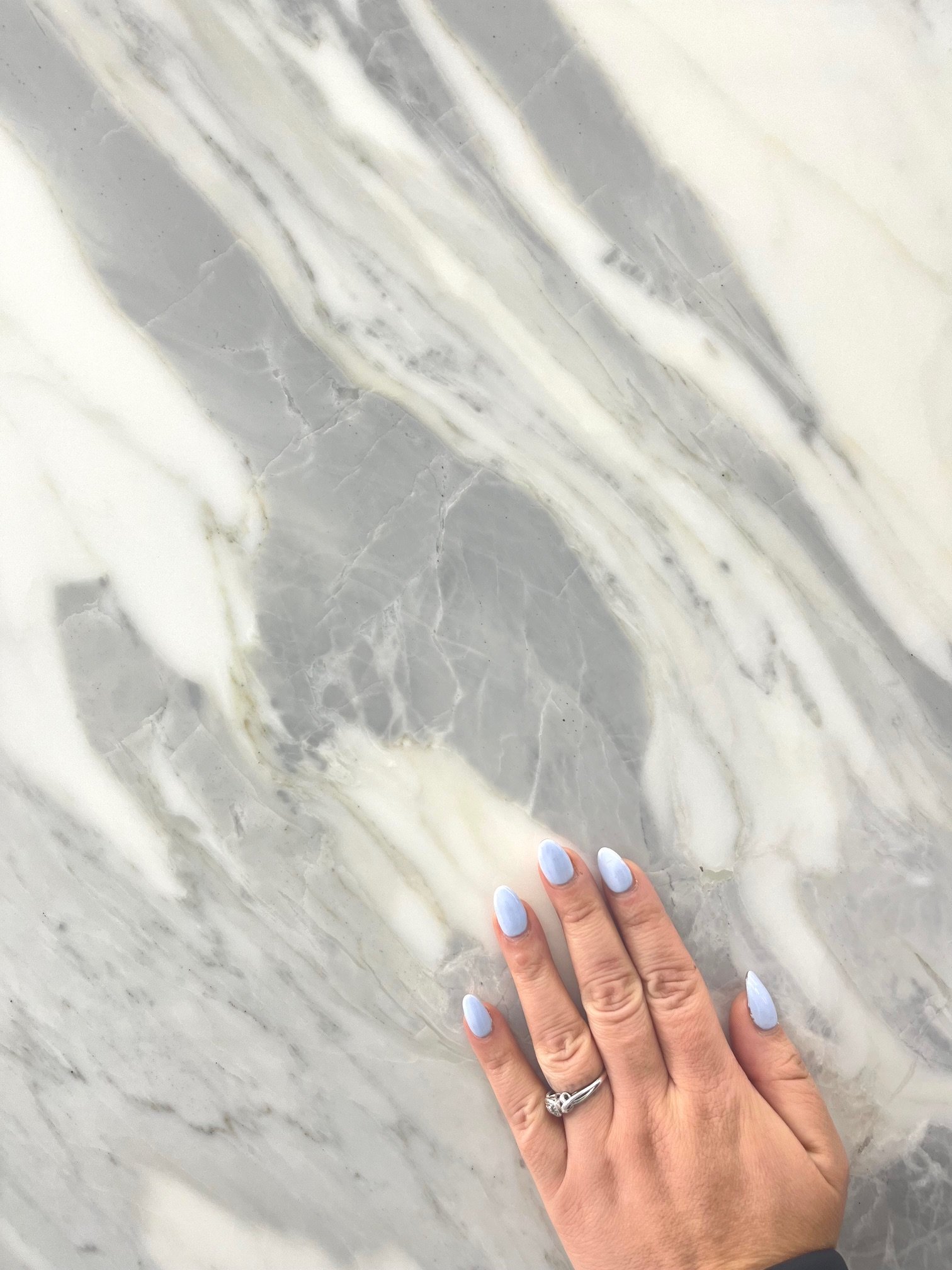Calacatta Carrara Close up with hand.jpg