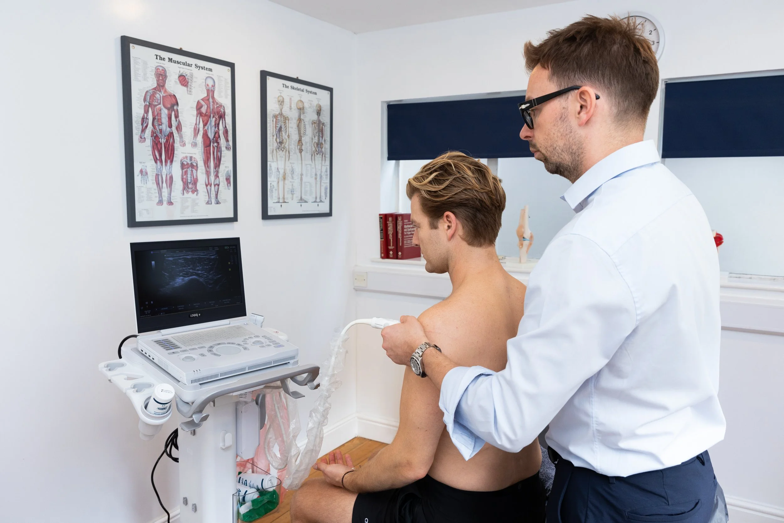 Clinician performing a diagnostic ultrasound examination on a patient's shoulder