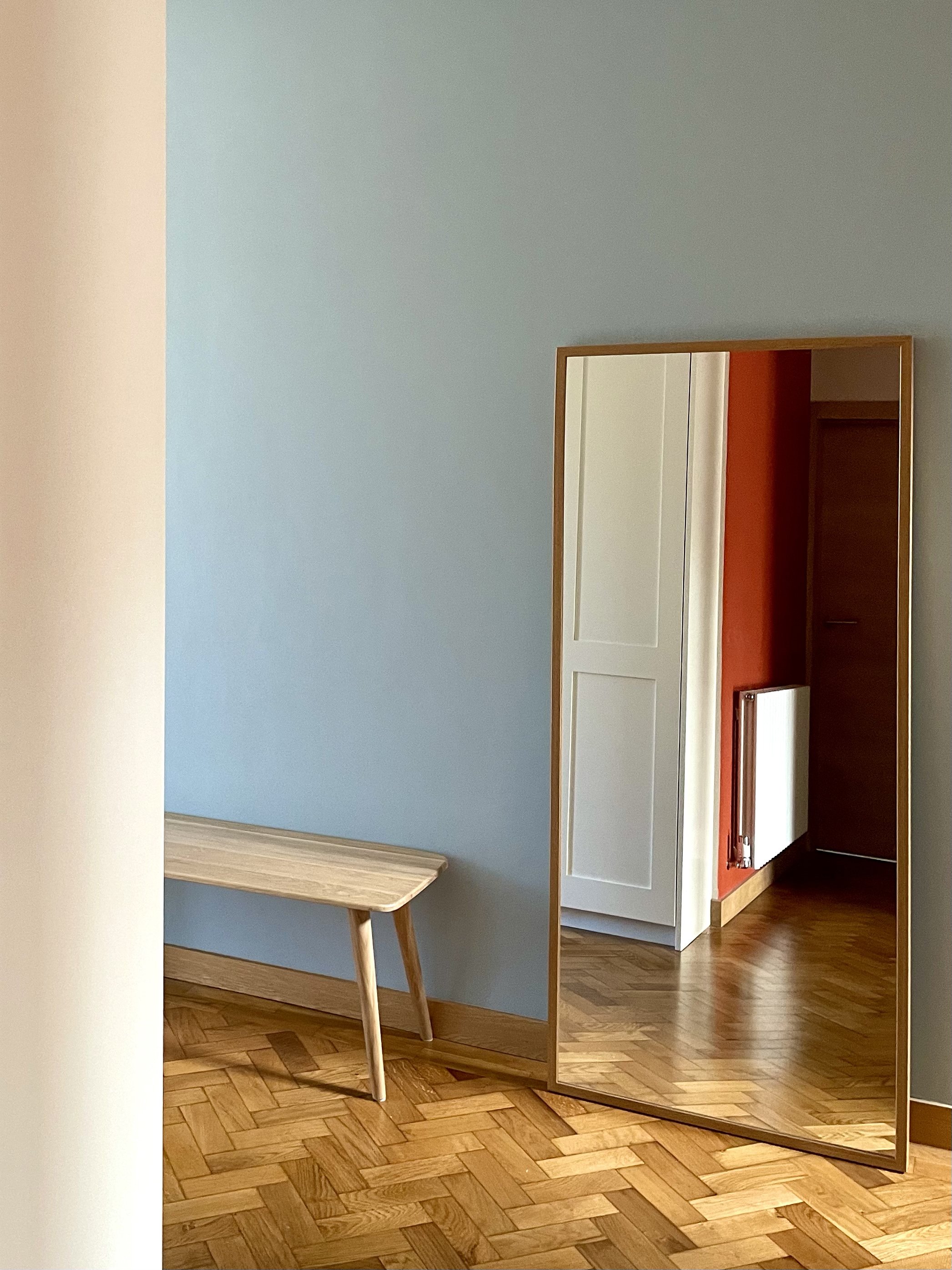 Charlotte Bucciero-Interiors-blue-wall-colourblocking-parquet-bench-mirror-reflection-hallway.jpg