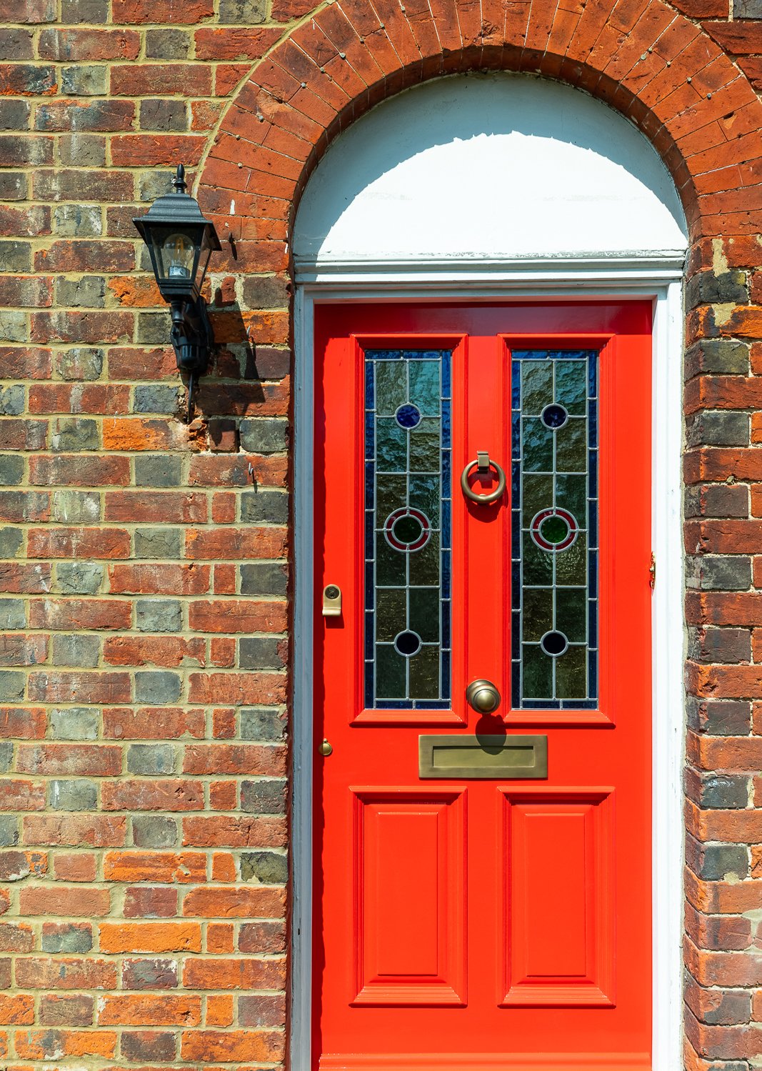 CharlotteBucciero-interiors-red-front-door-arch-stained-glass.jpg