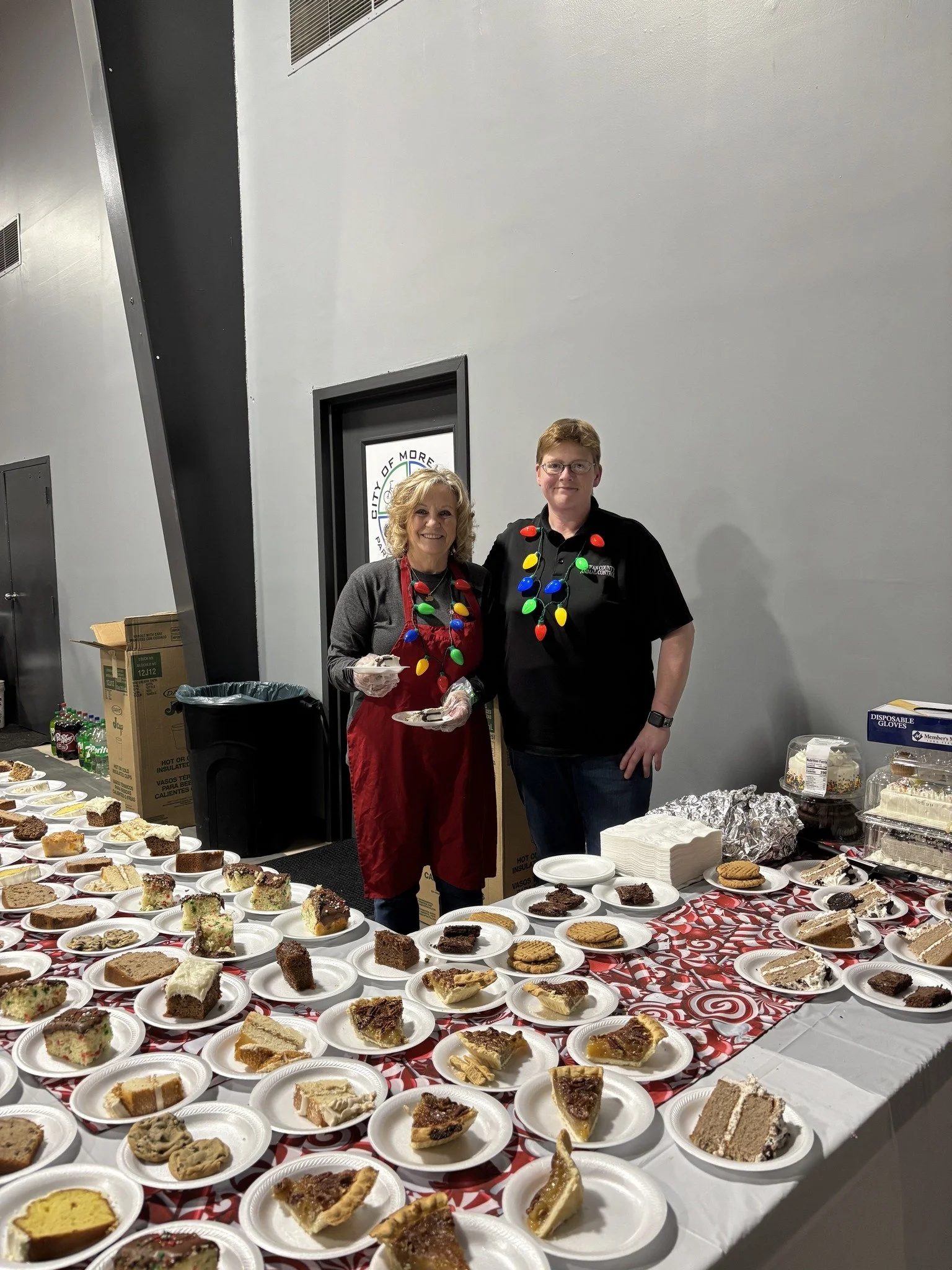 Pam and Kim serving desserts at the Annual City-County Christmas Dinner