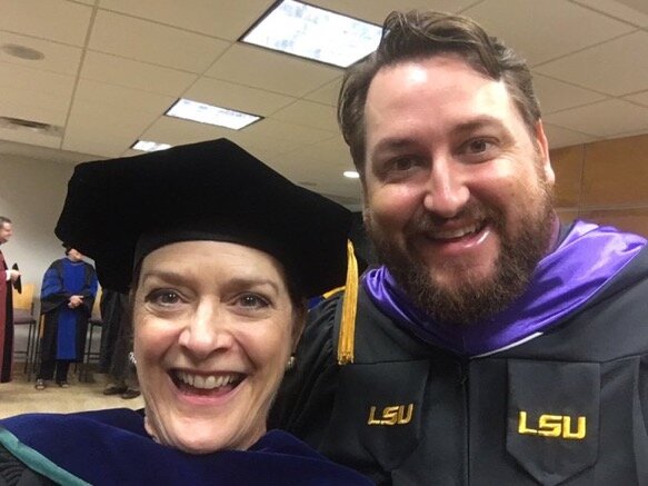Dean Stacy Haynie and Jay Ducote celebrate after LSU's commencement.