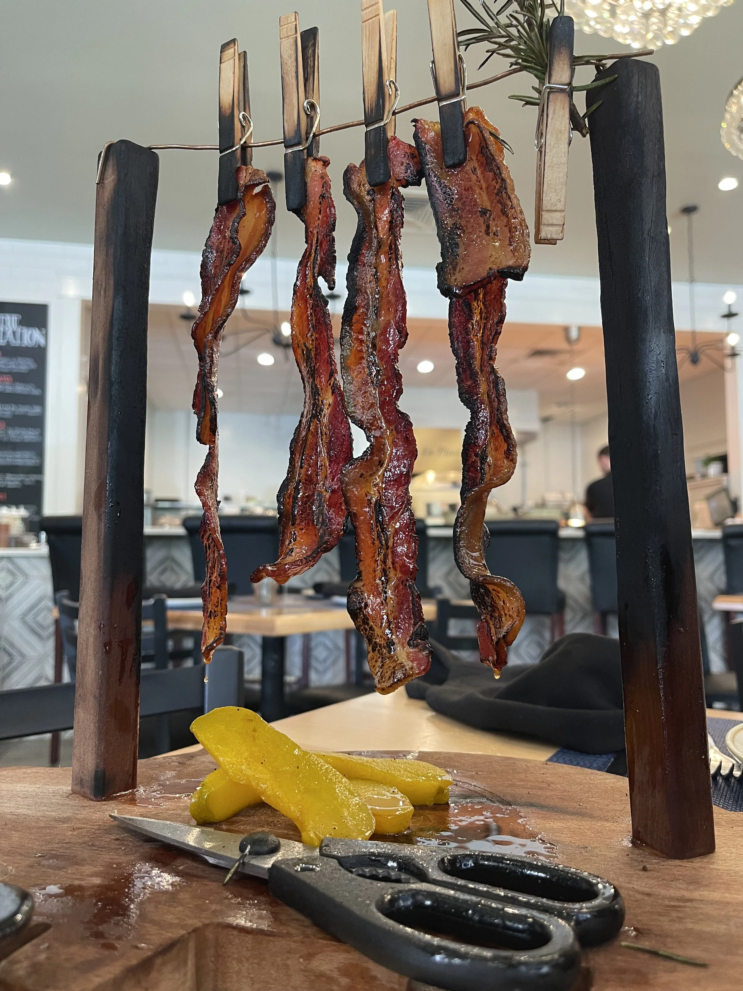 desi vegas smokehouse hanging bacon.jpeg