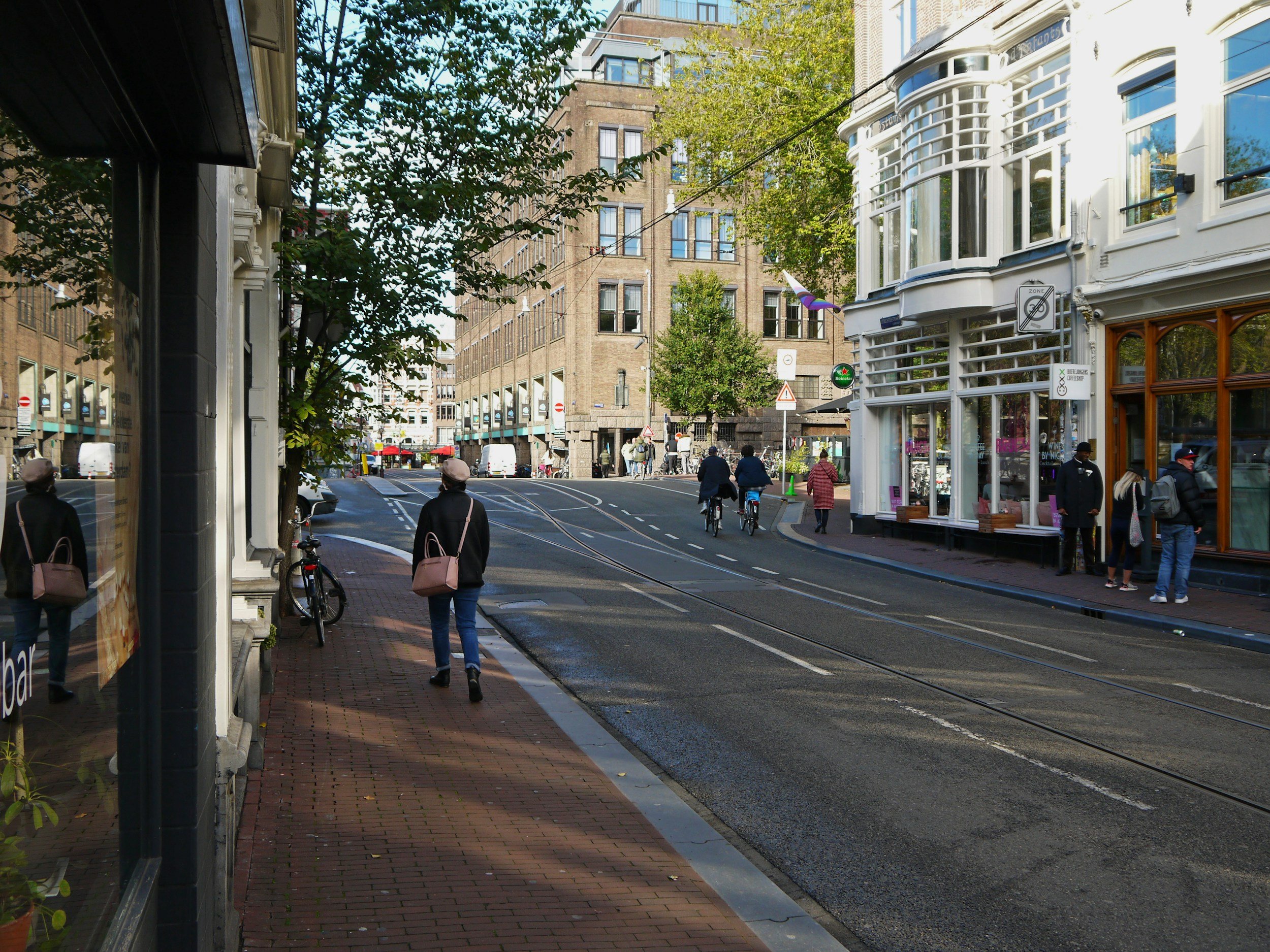 local Ontario neighbourhood with storefronts and people walking in the fall