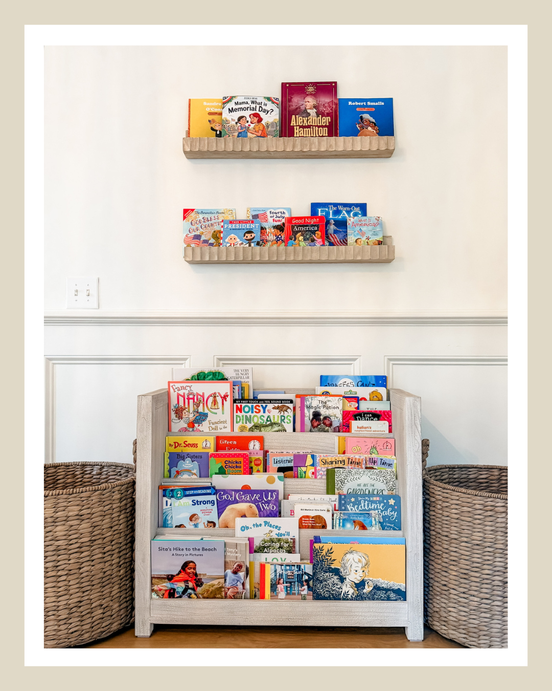 Organized kids reading nook with books displayed on wall shelves and book storage