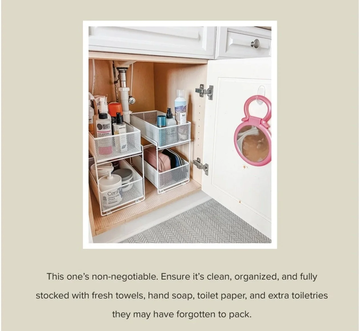 Neatly organized guest bathroom cabinet with labeled bins, toiletries, and fresh towels