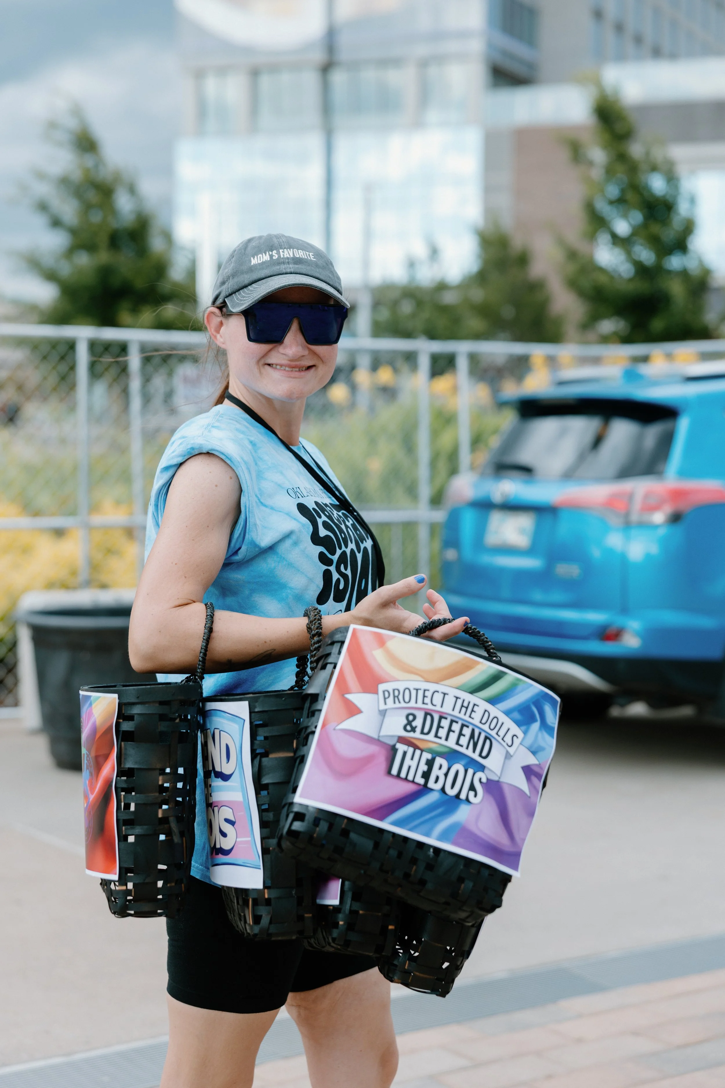 A PrideFest volunteer carrying bags.