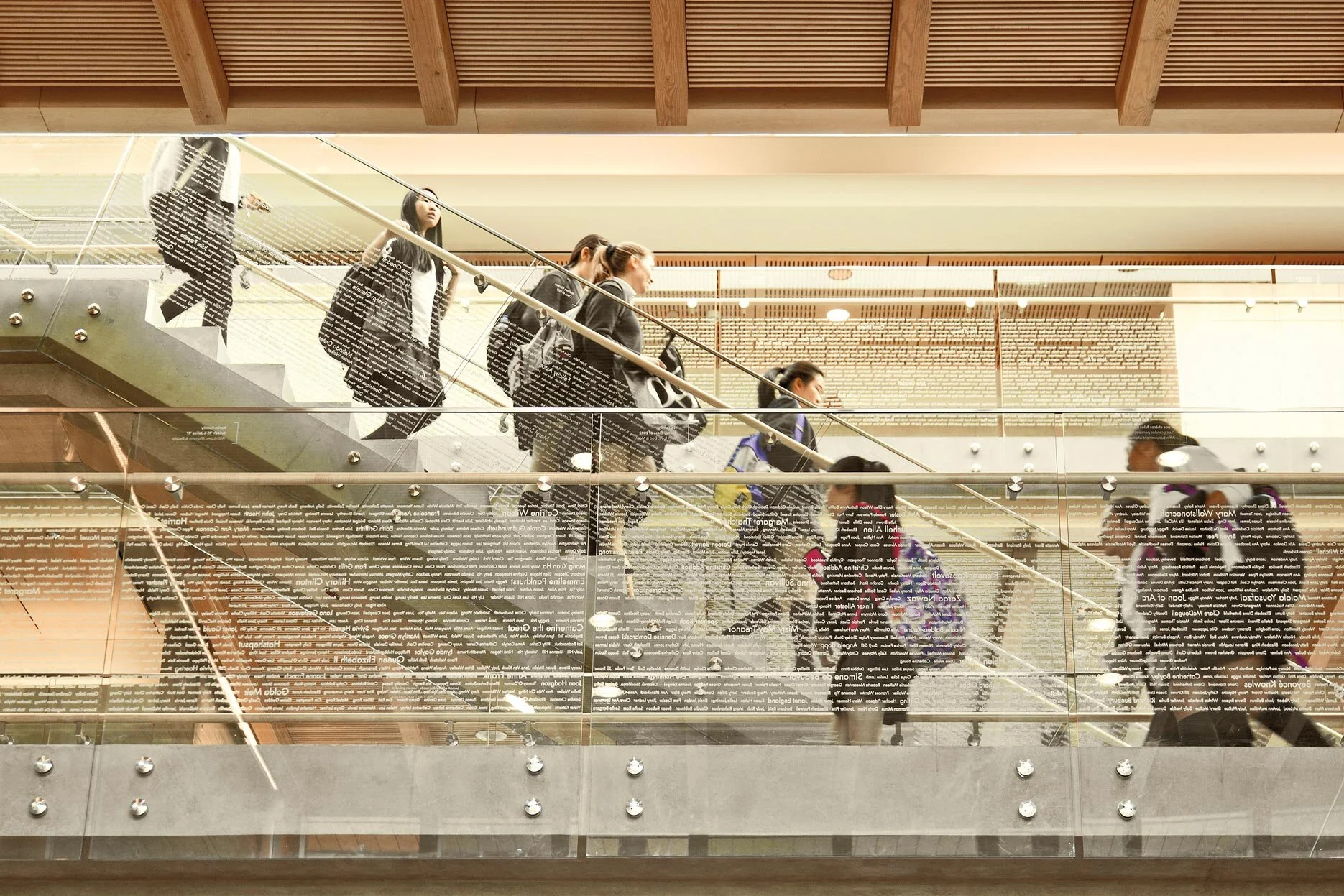 An interior side view of a staircase inside the York House Senior School with people walking up and down