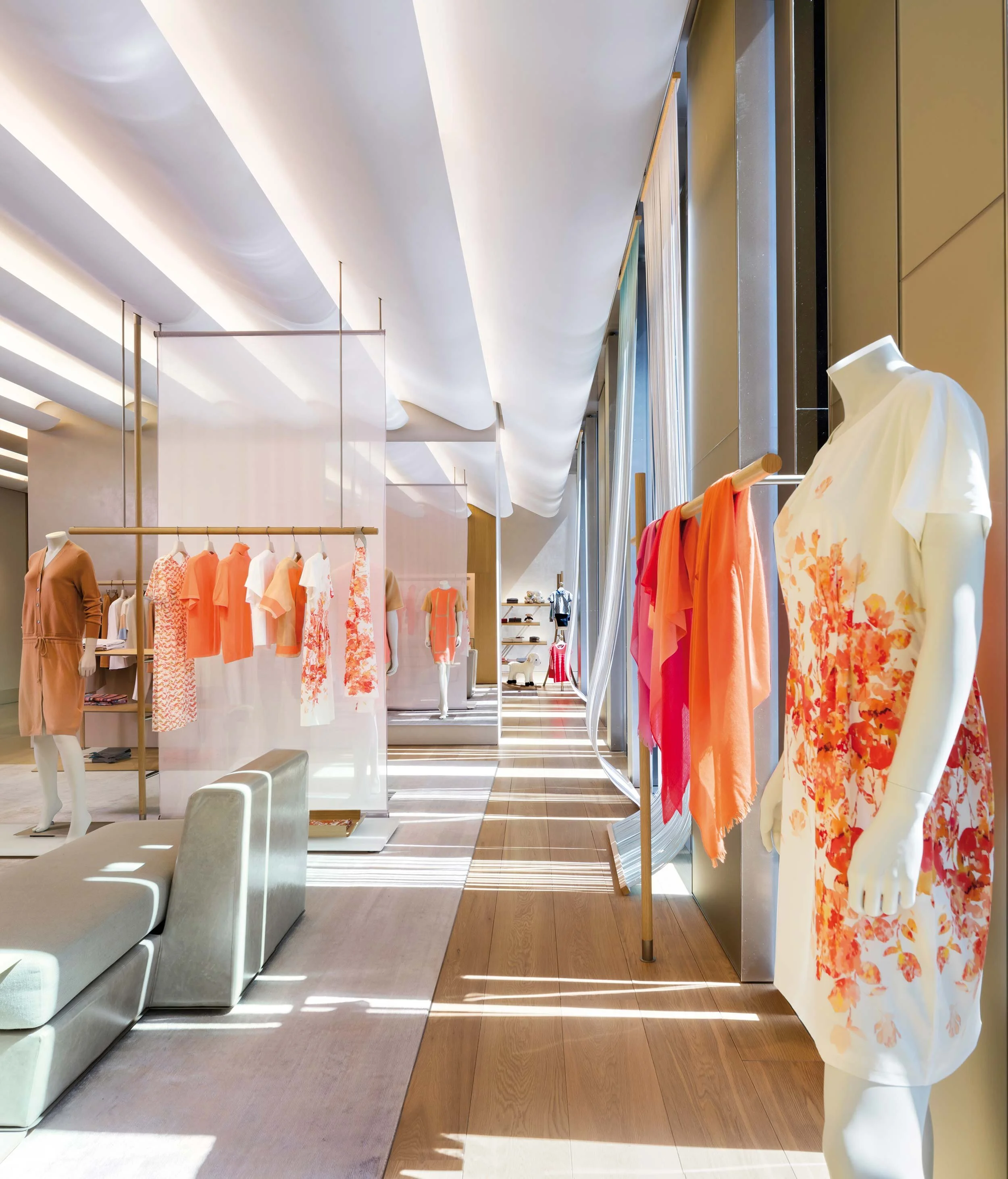 An interior view of models, clothing, and seating inside the 1436 Flagship Store