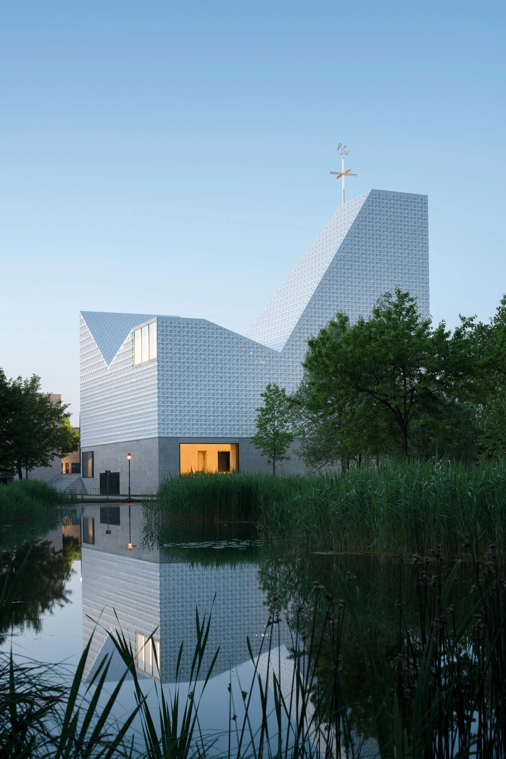 A side view of the Church of Seliger Pater Rupert Mayer from across the pond