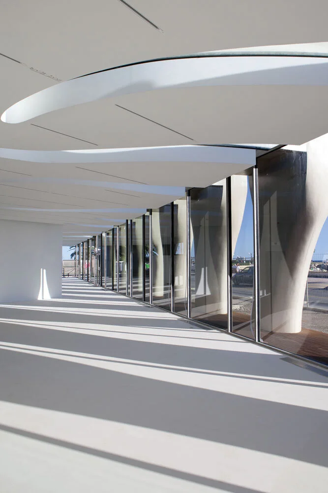 Musée Jean Cocteau interior showing organic strip ceiling and a glass windows to the right