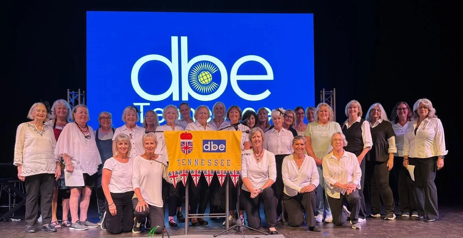 DBE in TN ladies all standing on a stage with their banner