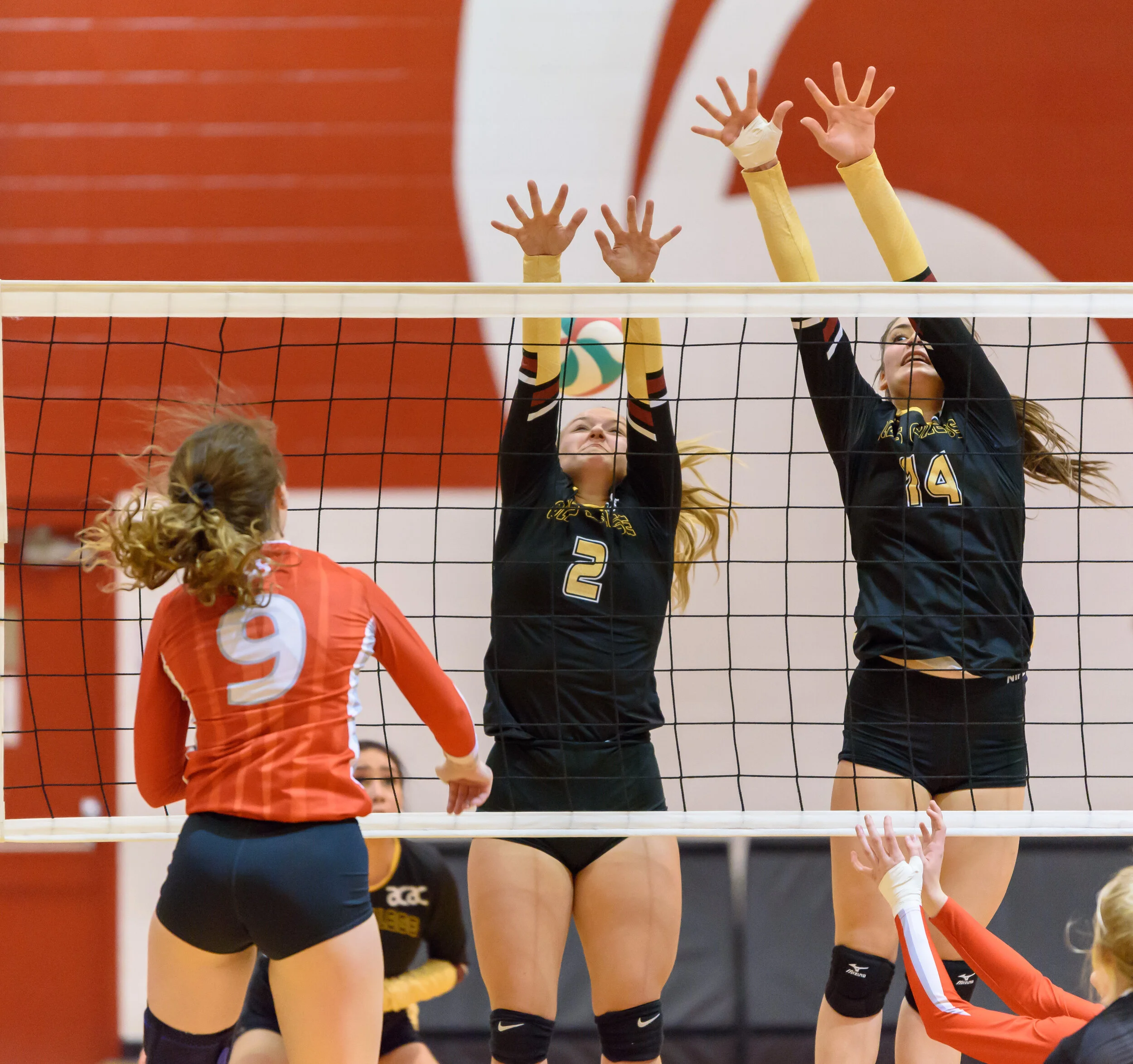  SAIT Trojans Anika Dyck, spikes the ball past Natalya Hauser, left, and Janeen Pellatt of the Olds College Broncos during Alberta Colleges Athletic Conference regular-season play at the Campus Centre in Calgary on Friday, Oct. 25, 2019. The Broncos 