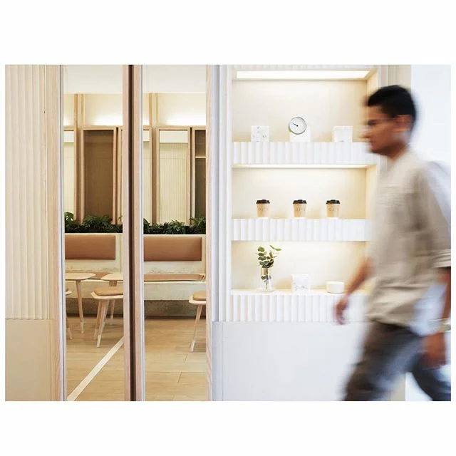 the textured painted corrugated walls mimic the arched ceiling design to create a strong sense of unity within the space.
.
backlit pocket shelves are mounted for the purpose of retail.
.
[ swipe left for more detailed images ]

ojs coffee | tea/ com