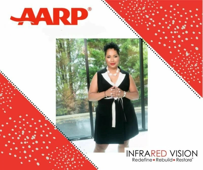 A woman standing in front of a window with trees outside, dressed in a black and white outfit with jewelry. The image is part of an AARP promotional graphic with red and white design elements. The text reads 'AARP' at the top and 'Infrared Vision' with the tagline 'Redefine, Rebuild, Restore' at the bottom.