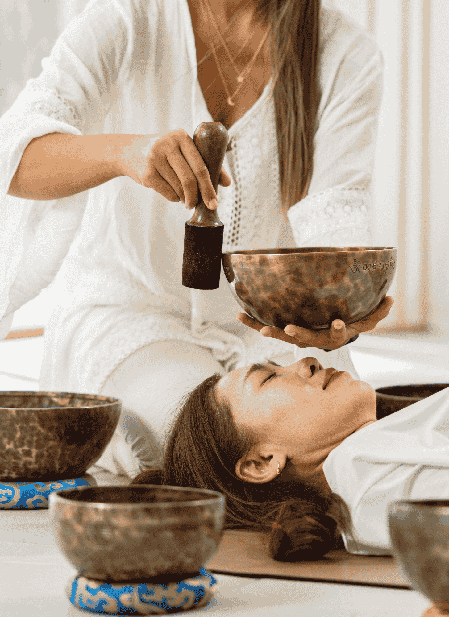 A Sound Healer giving a student a sound bath